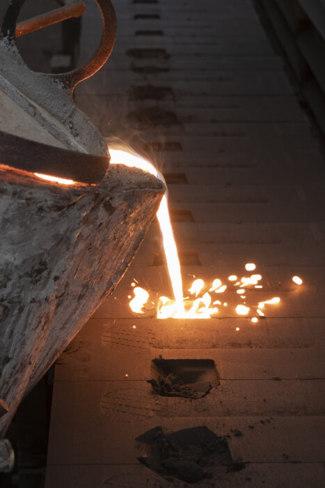 Iron molten metal pouring in sand mold ; green sand process