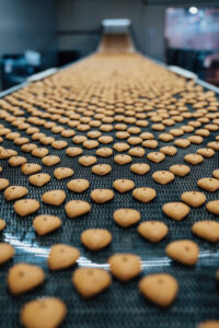 Huge factory line for sweet food and cookies production. Close up shots of industrial manufacturing process.